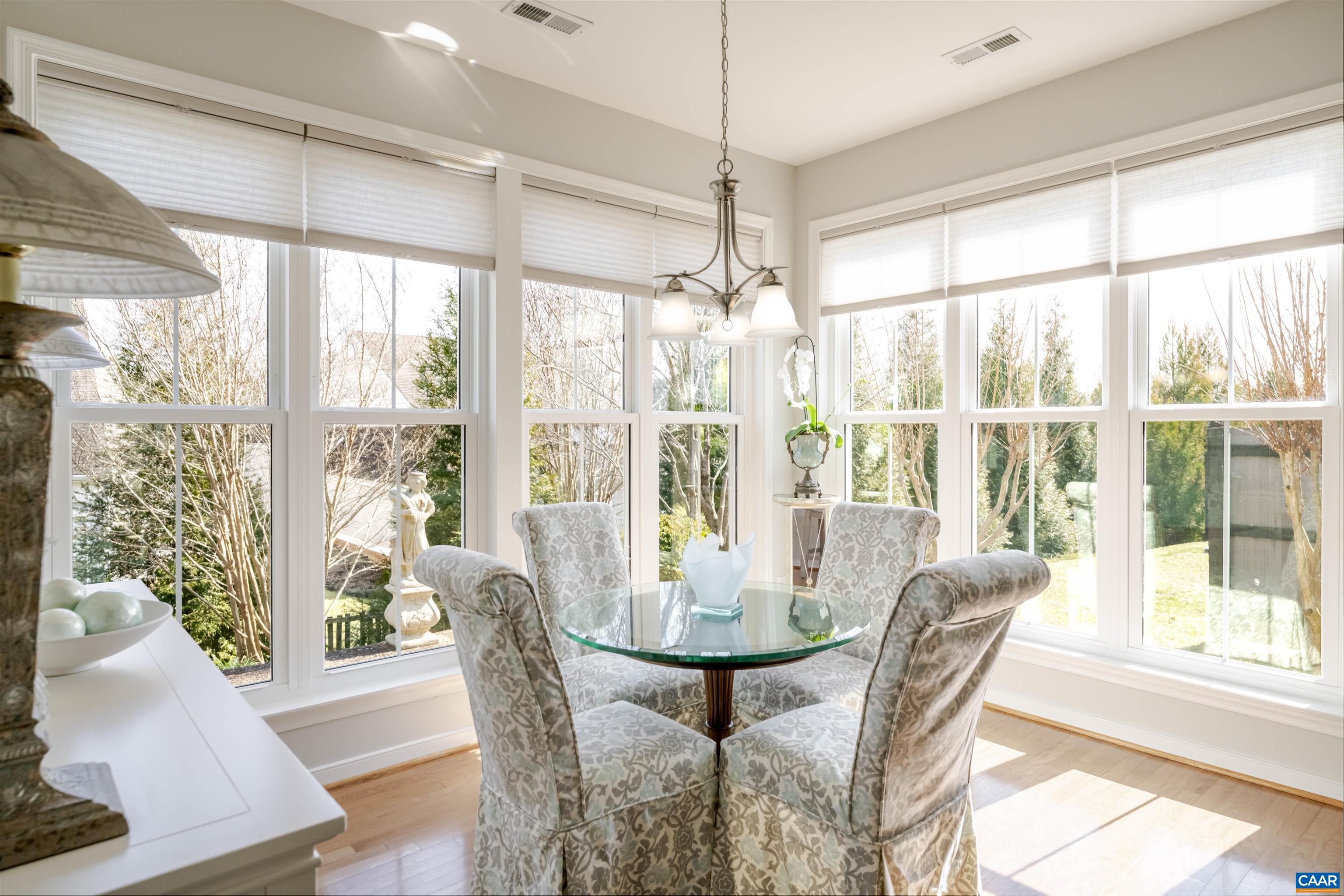 1322 Stonegate Court Crozet, VA 22932 - Photo 12 of 39 a view of a dining room with furniture large windows and wooden floor