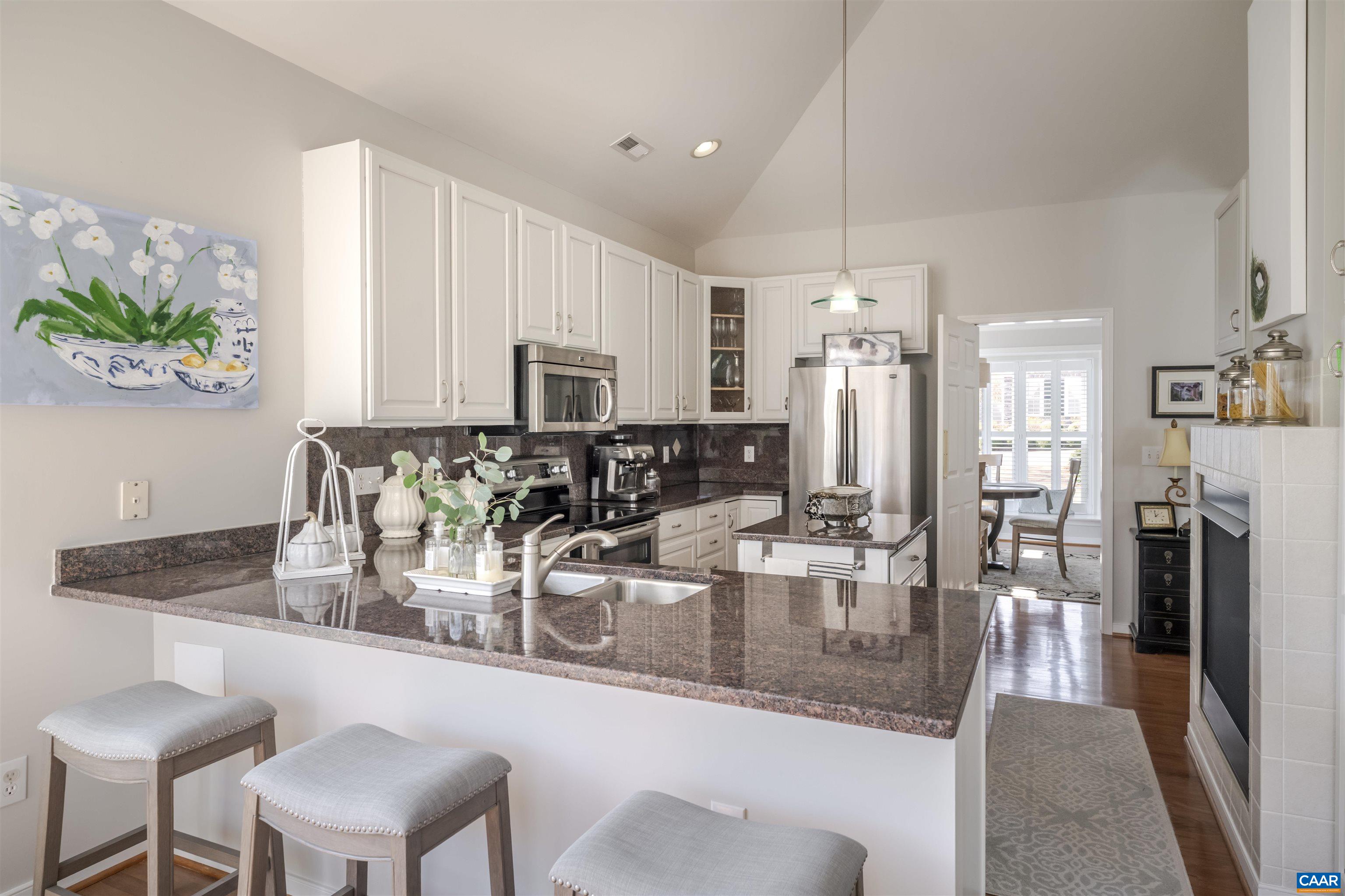 1322 Stonegate Court Crozet, VA 22932 - Photo 15 of 39 a kitchen with kitchen island granite countertop a table and chairs