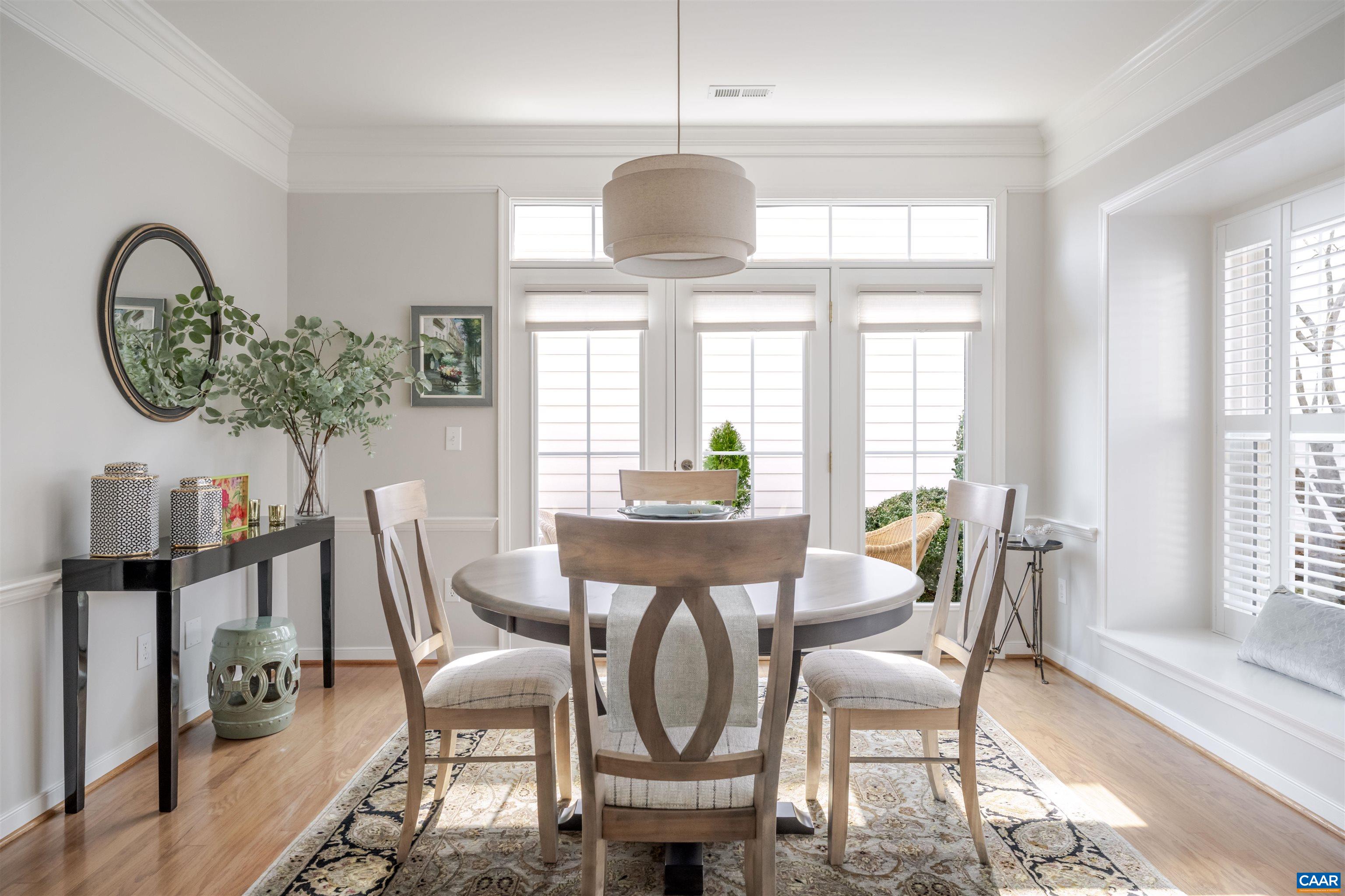 1322 Stonegate Court Crozet, VA 22932 - Photo 8 of 39 a dining room with furniture a potted plant and a chandelier