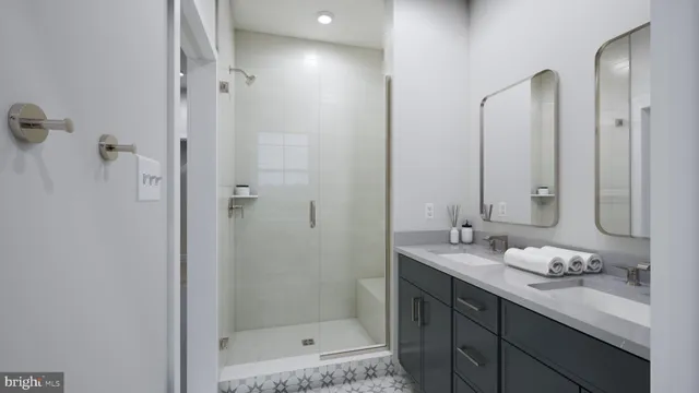 a bathroom with a granite countertop sink two mirror and shower
