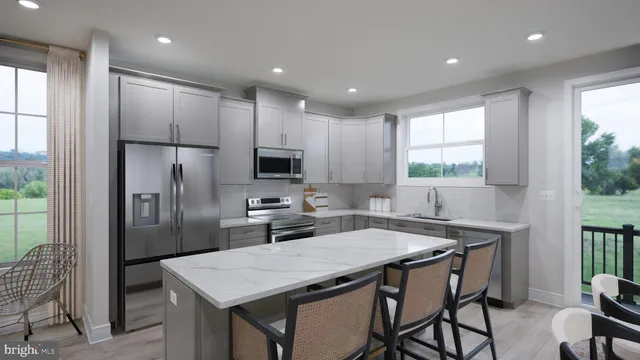 a kitchen with a table chairs refrigerator and microwave