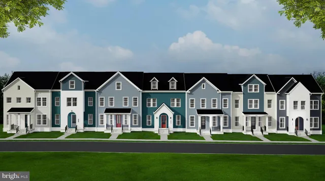 a front view of a house with a yard and trees