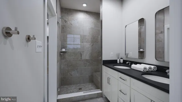 a bathroom with a granite countertop sink a mirror and a shower