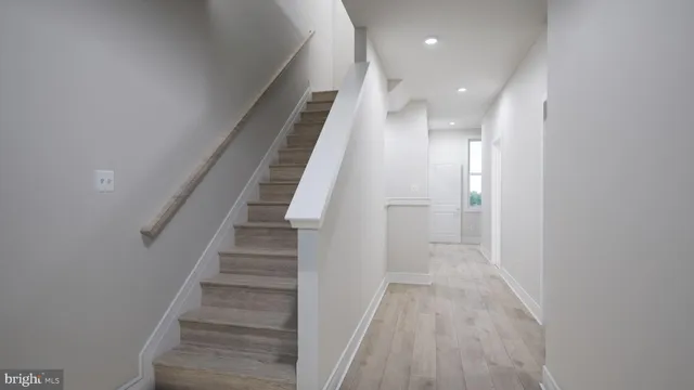 a view of entryway and hall with wooden floor