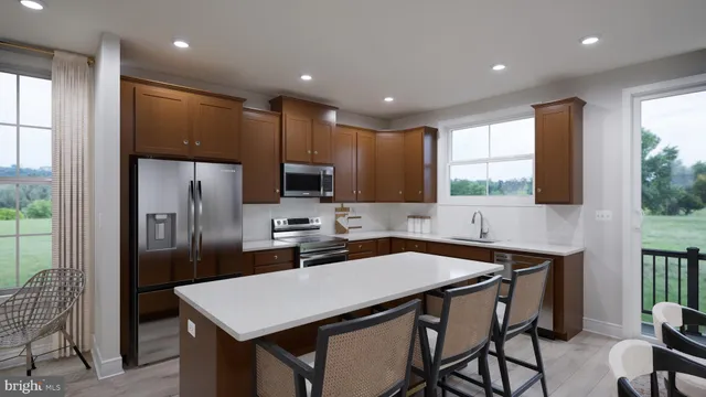 a kitchen with a table chairs refrigerator and microwave