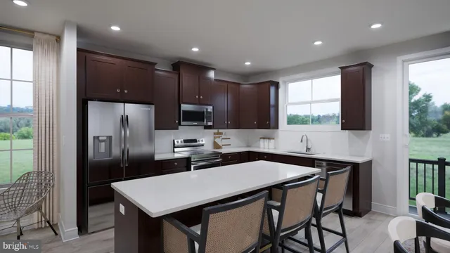 a kitchen with a table chairs refrigerator and microwave