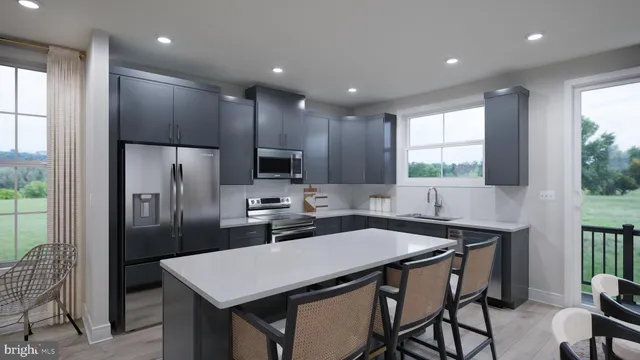 a kitchen with a table chairs refrigerator and microwave