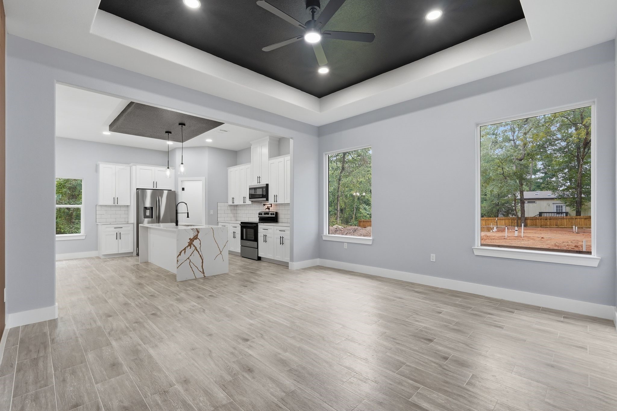 3575 Roy Bean Road Willis, TX 77378 - Photo 6 of 40 a view of empty room with wooden floor and fan