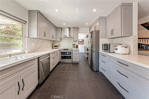 a kitchen with cabinets and window