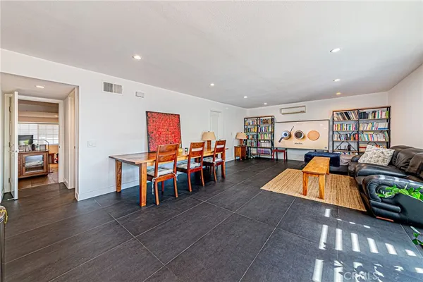 a living room with furniture and a open kitchen view