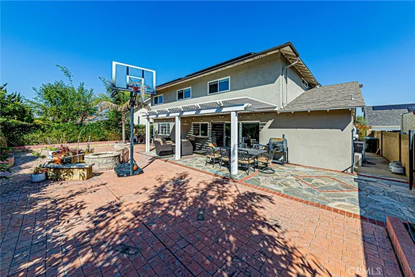 a view of a house with backyard porch and sitting area