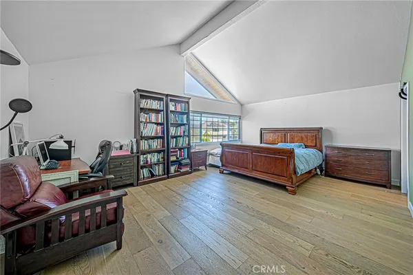 a bed sitting in a bedroom next to a window