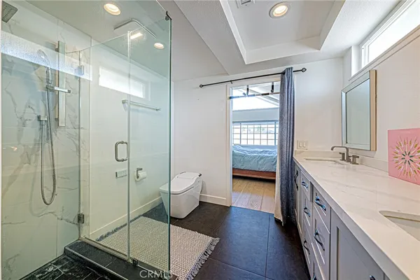 a bathroom with a sink mirror vanity and toilet