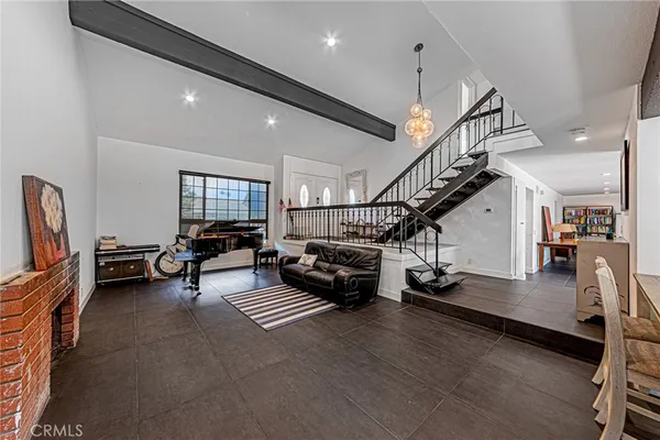 a living room with lots of furniture and a wooden floor