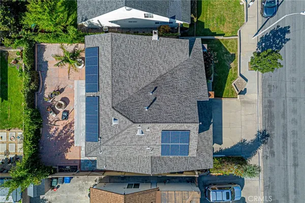 an aerial view of a house with garden space and street view