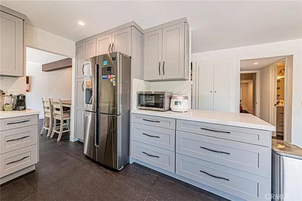 a kitchen with stainless steel appliances granite countertop refrigerator sink and cabinets