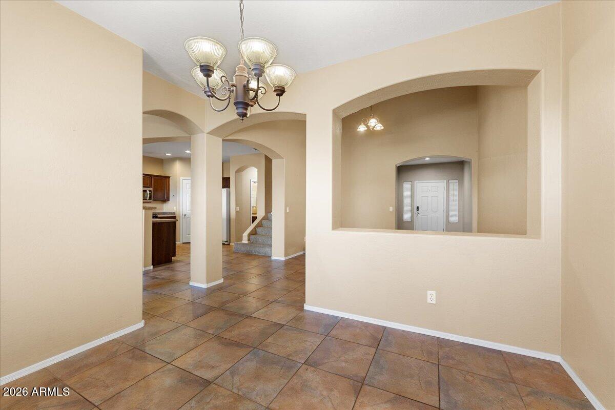 813 Alfonse Road Clarkdale, AZ 86324 - Photo 10 of 41 a view of a hallway with wooden floor and a chandelier