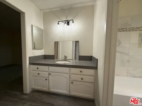 a bathroom with a double vanity sink and mirror