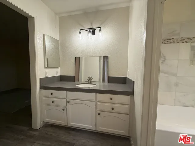 a bathroom with a double vanity sink and mirror