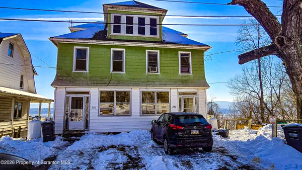 a front view of a house with parking