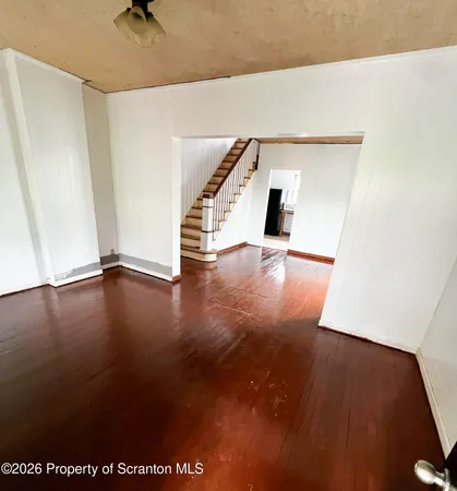 a view of a room with wooden floor and chair