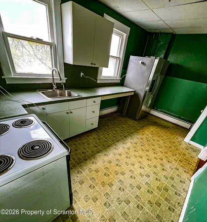a kitchen with a stove and a sink