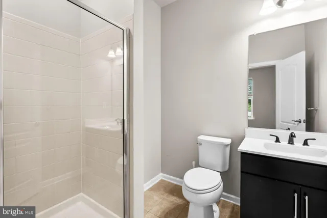 a bathroom with a sink toilet and a mirror