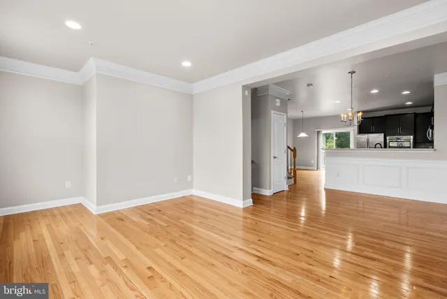 a view of a kitchen with a sink and a refrigerator