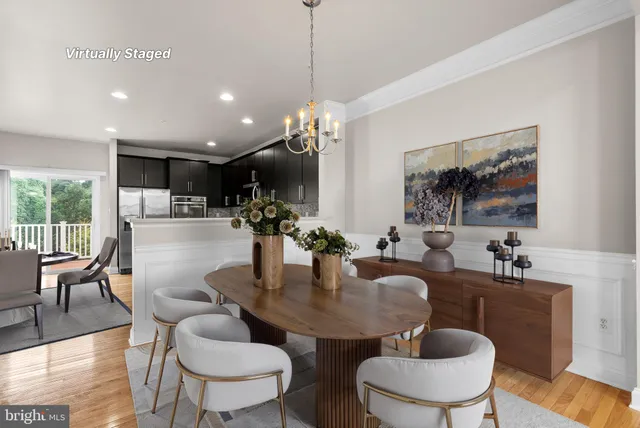 a kitchen with kitchen island a dining table and chairs