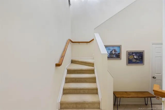 a kitchen with stainless steel appliances a dining table and chairs