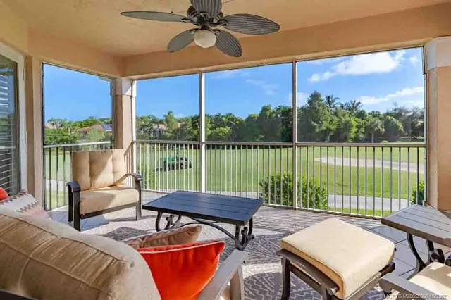 a living room with furniture and a ceiling fan