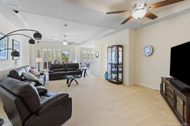 a bedroom with a bed and dresser with wooden floor