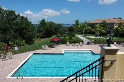 a room with lots of white furniture and windows