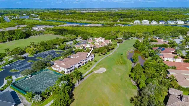 an aerial view of residential houses with outdoor space and street view