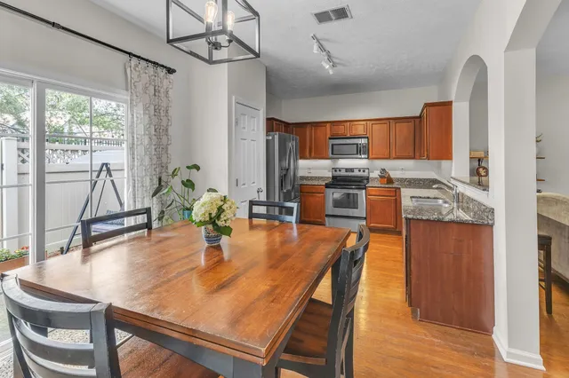 a kitchen with granite countertop a refrigerator stove and microwave