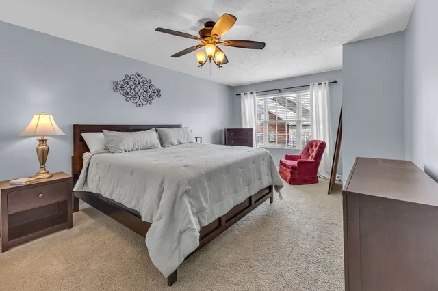 a bedroom with a bed and a chandelier