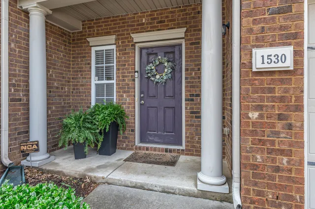 a view of a hallway with wooden floor and stairs
