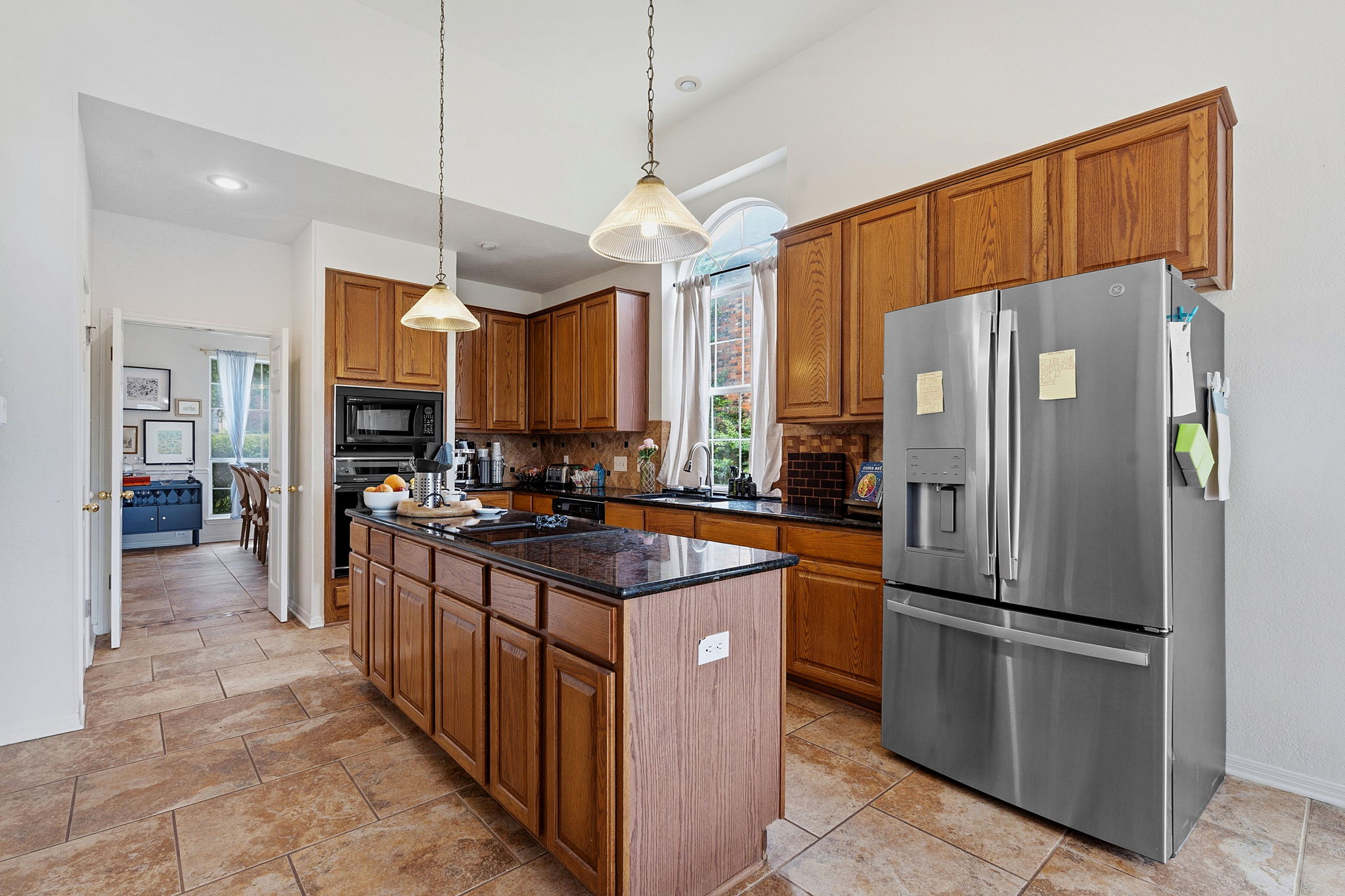 8317 Pommel Drive Austin, TX 78759 - Photo 6 of 26 Culinary aspirations come alive in this kitchen, boasting rich wood cabinetry, an island, and sleek stainless appliances.