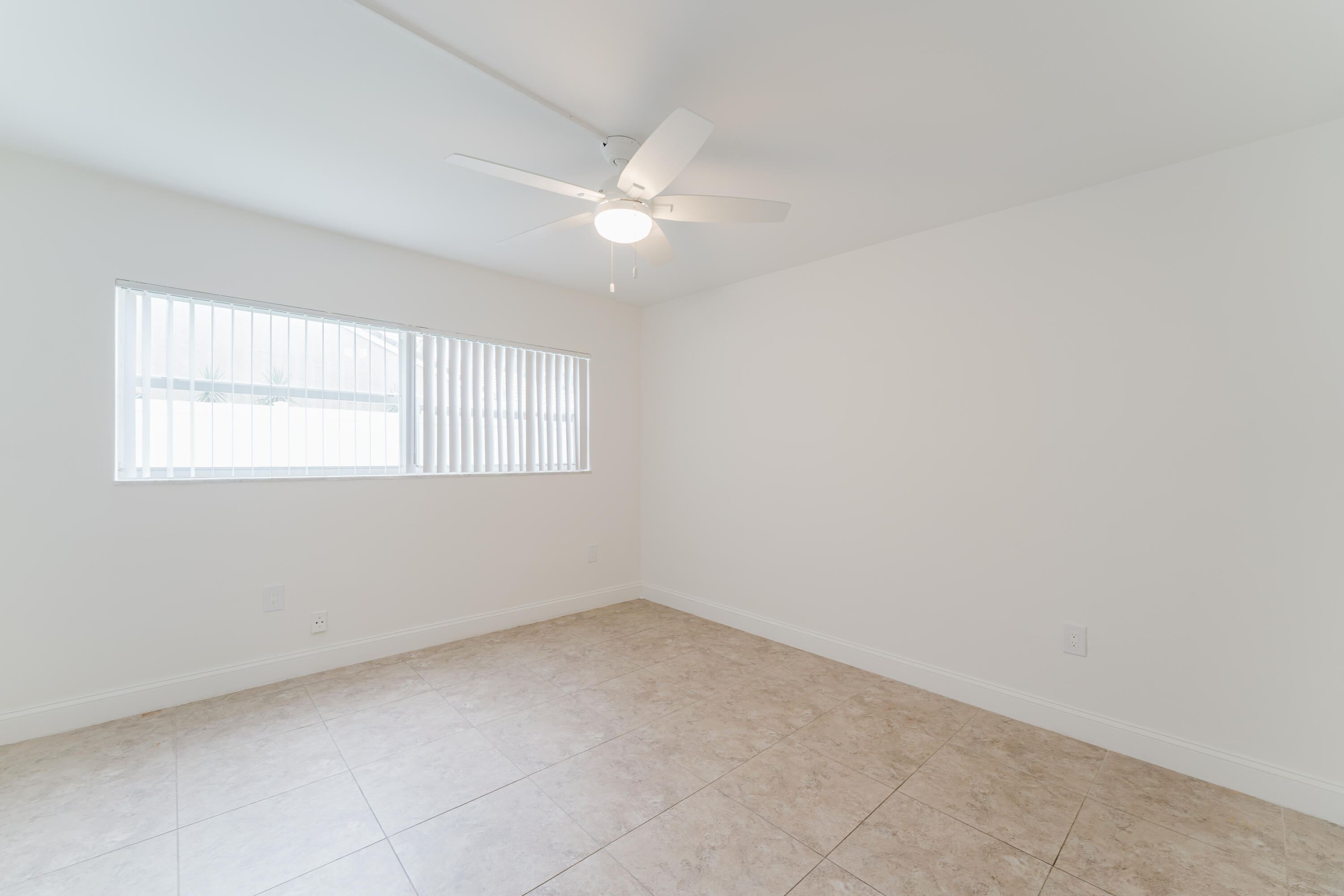 601 Southwest 2nd Avenue, Unit 5 Boca Raton, FL 33432 - Photo 20 of 26 an empty room with a window and a fan