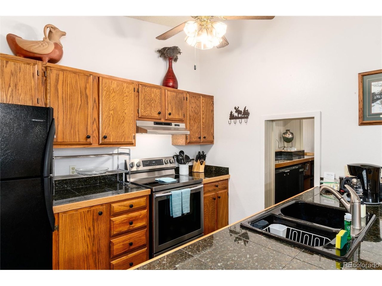 490 Kings Crossing Road, Unit 631 Winter Park, CO 80482 - Photo 20 of 43 a kitchen with stainless steel appliances a stove a refrigerator and cabinets