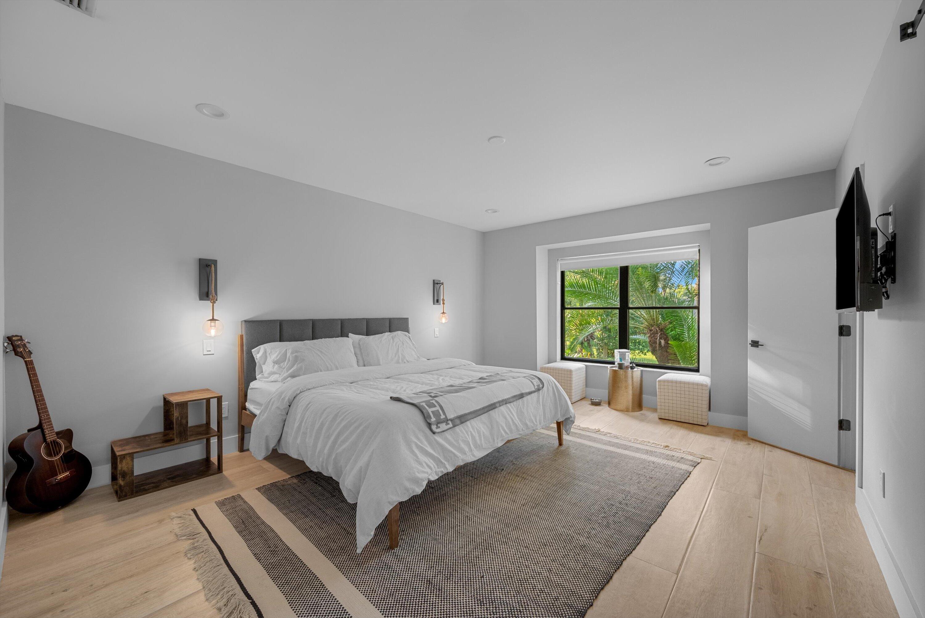 13224 Polo Club Road, Unit A204 Wellington, FL 33414 - Photo 12 of 27 a spacious bedroom with a bed and a large window