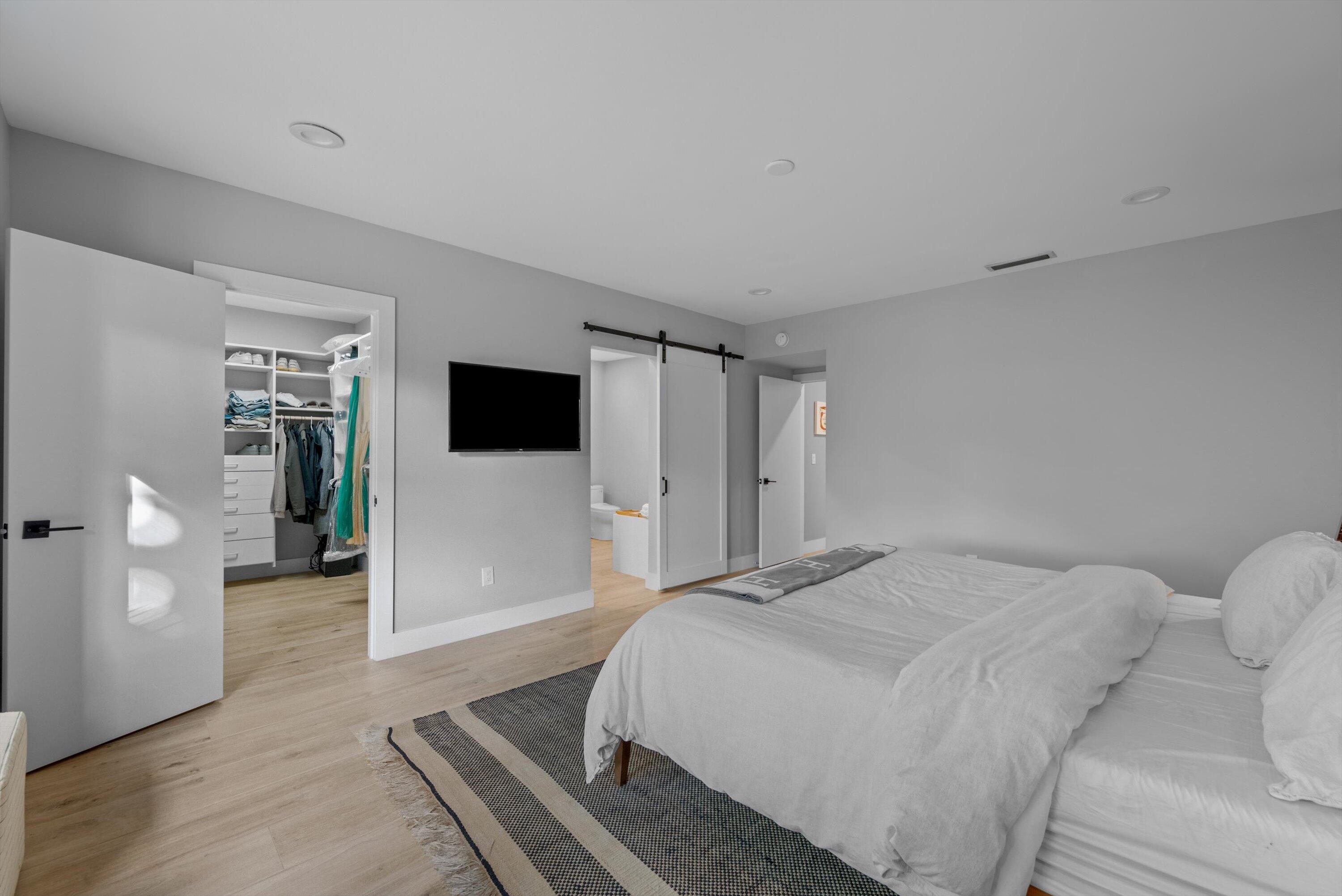 13224 Polo Club Road, Unit A204 Wellington, FL 33414 - Photo 13 of 27 a bedroom with a bed and a flat screen tv