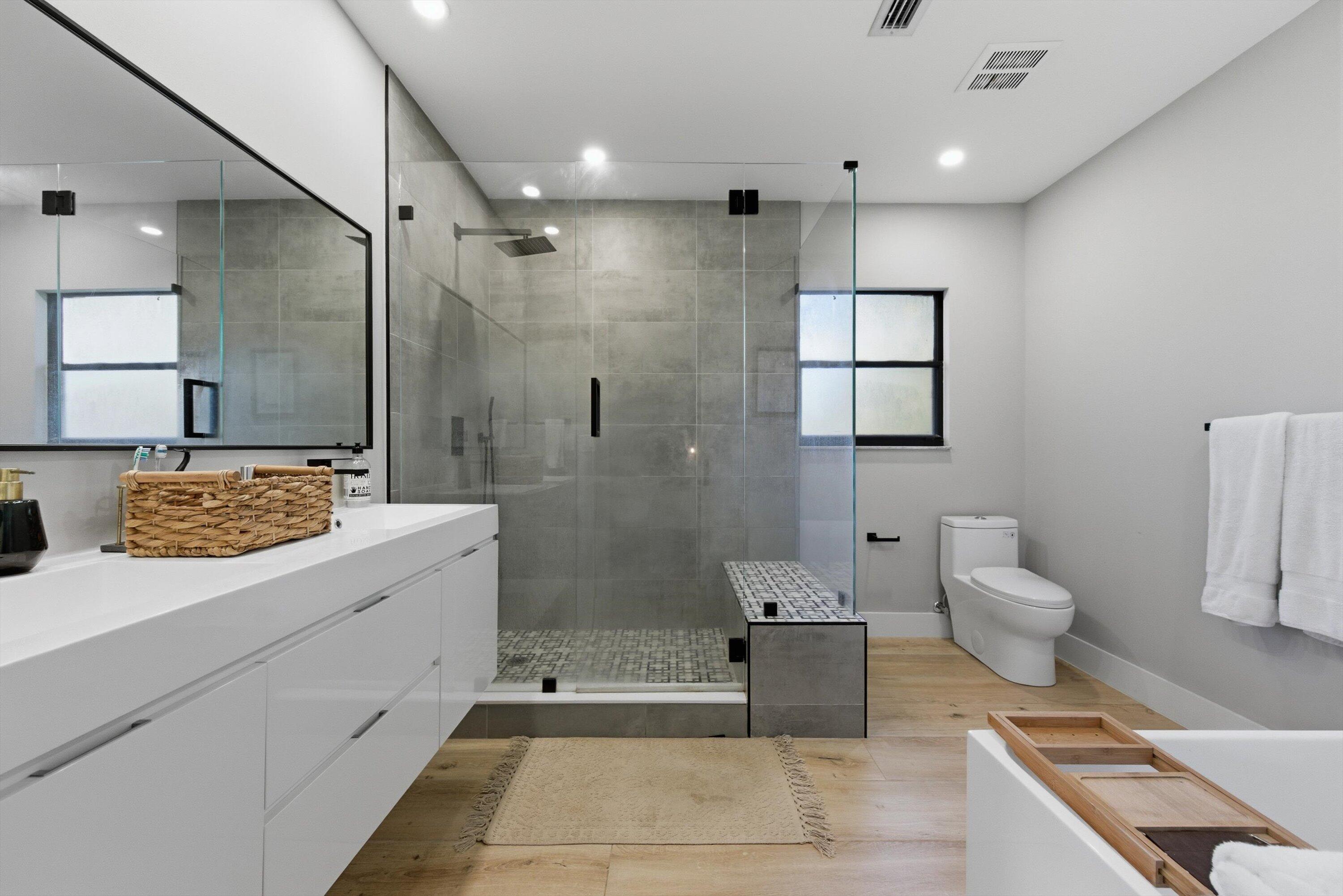 13224 Polo Club Road, Unit A204 Wellington, FL 33414 - Photo 14 of 27 a bathroom with a granite countertop sink a toilet and shower