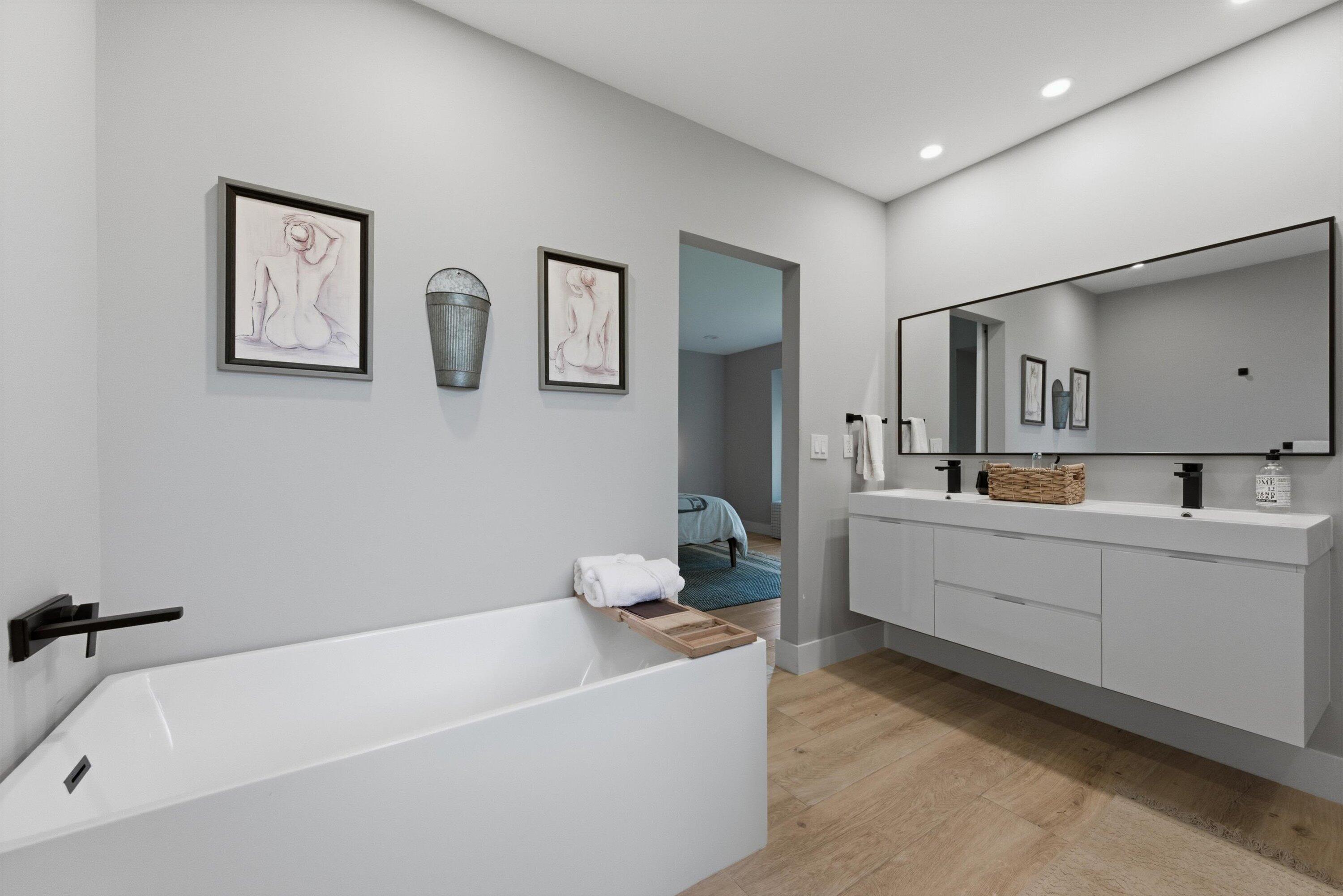 13224 Polo Club Road, Unit A204 Wellington, FL 33414 - Photo 16 of 27 a bathroom with a bathtub a sink and mirror