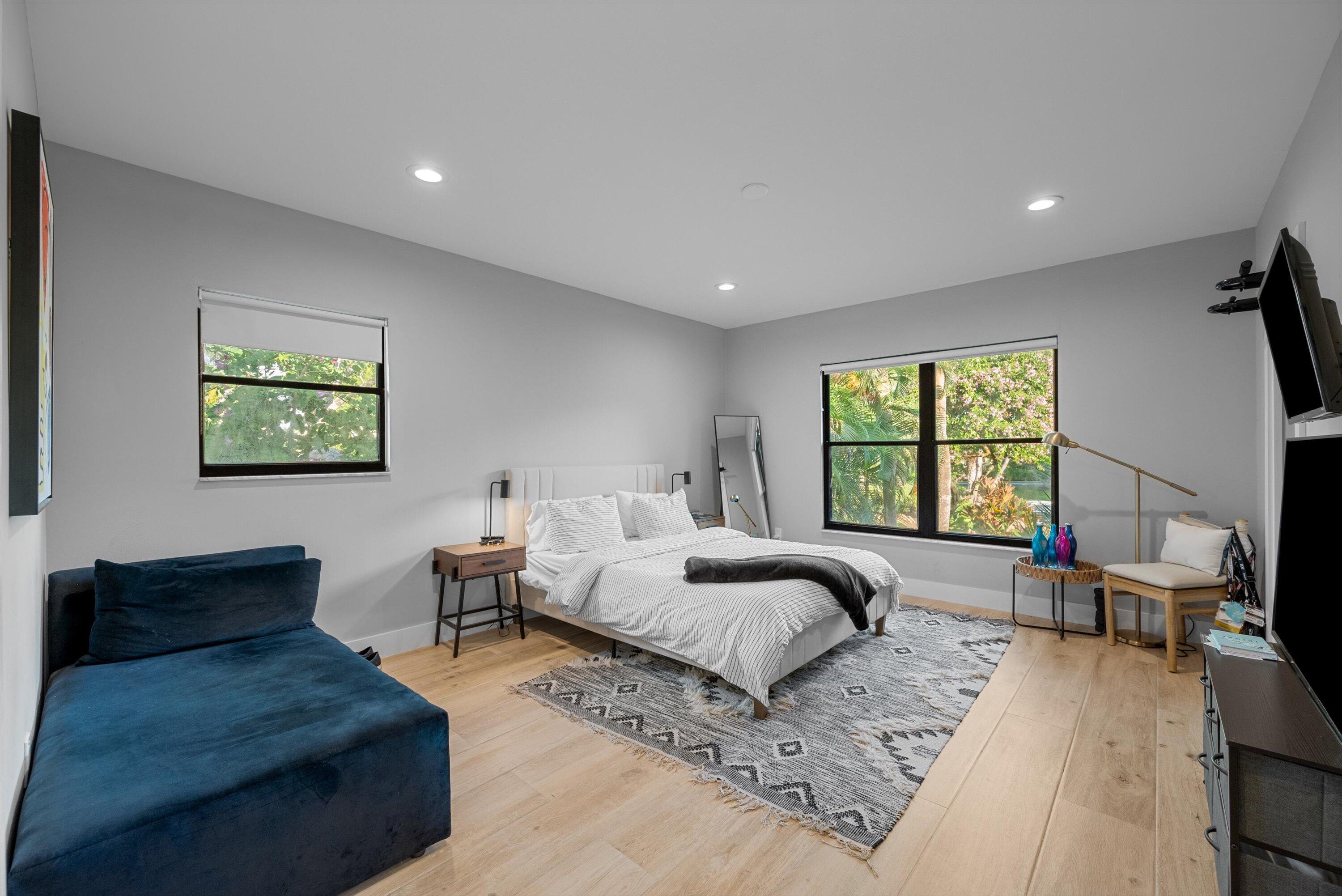 13224 Polo Club Road, Unit A204 Wellington, FL 33414 - Photo 18 of 27 a bedroom with furniture and a large window