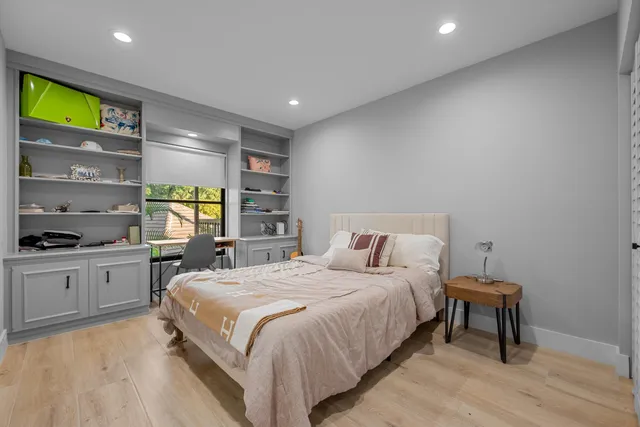 a bedroom with a bed and a dresser