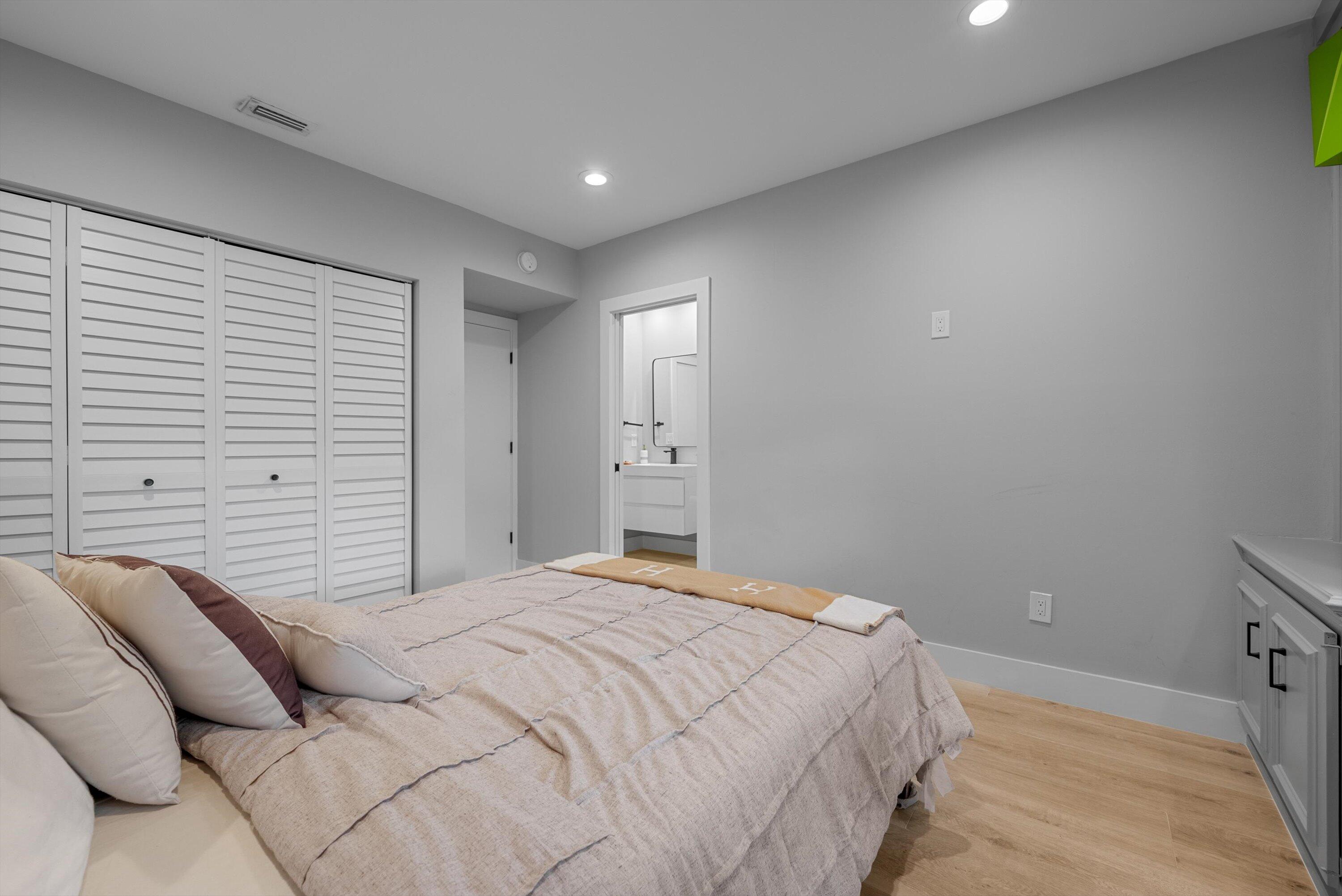 13224 Polo Club Road, Unit A204 Wellington, FL 33414 - Photo 22 of 27 a bedroom with a bed and a night stand