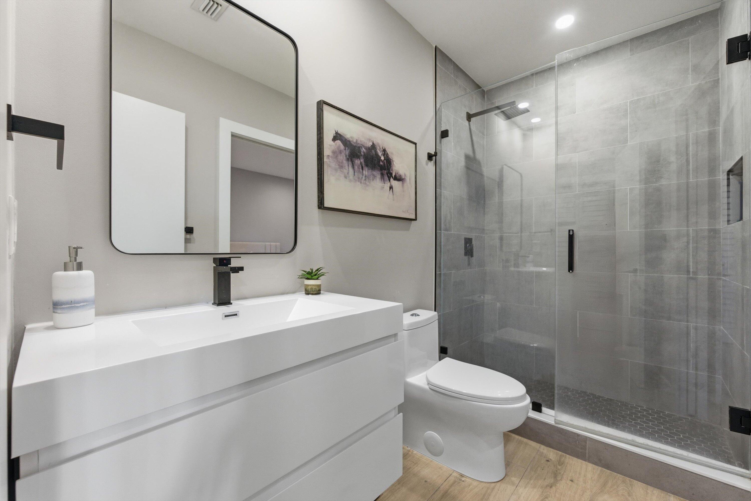 13224 Polo Club Road, Unit A204 Wellington, FL 33414 - Photo 23 of 27 a bathroom with a toilet sink and shower