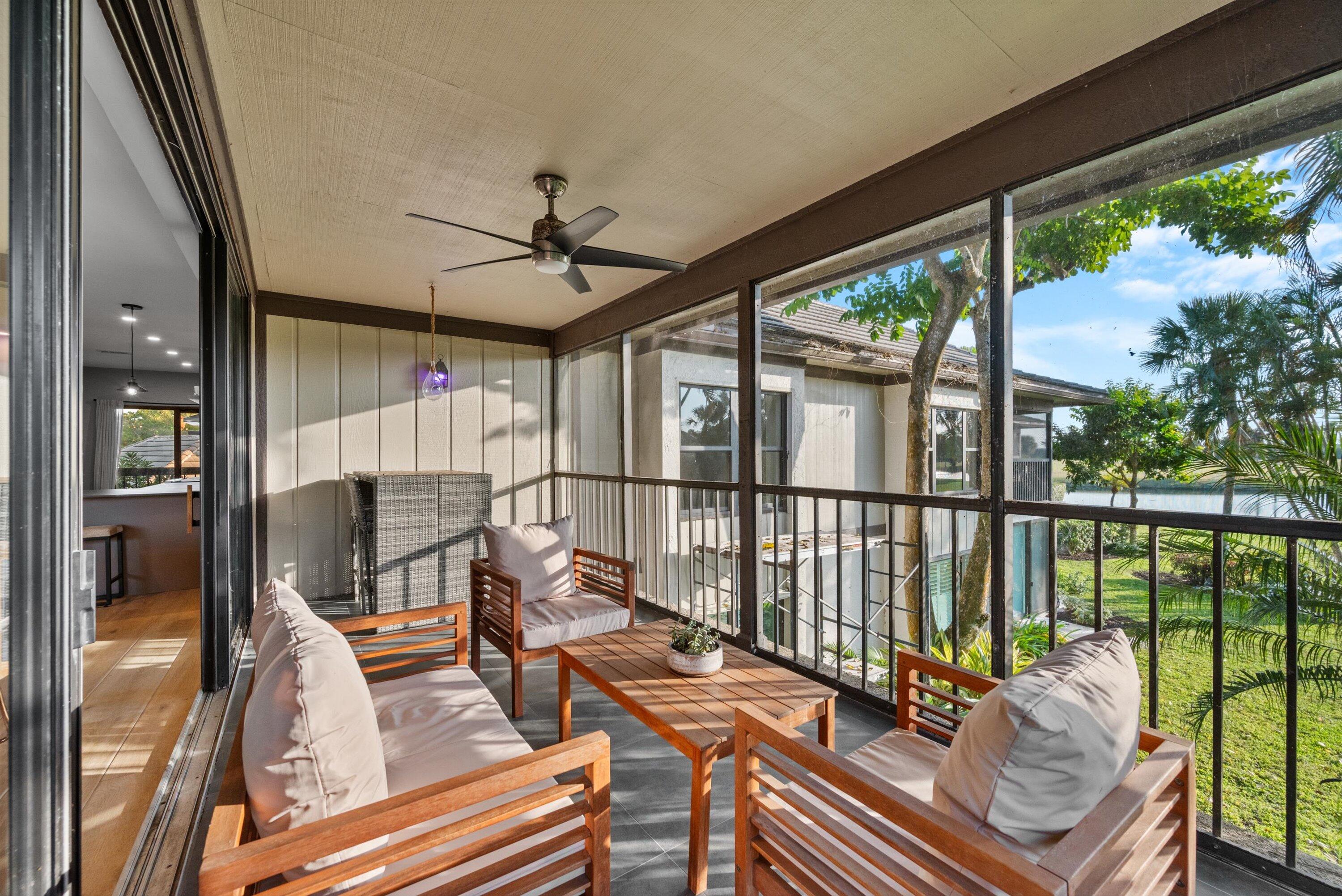 13224 Polo Club Road, Unit A204 Wellington, FL 33414 - Photo 4 of 27 a view of a balcony with chair and wooden floor