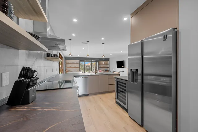 a kitchen with a refrigerator and a sink